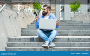 A person checking an online betting platform on a mobile phone carefully before signing up